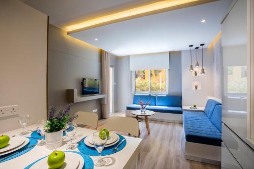a living room and dining room with a table and chairs at Malama Beach Holiday Village in Protaras