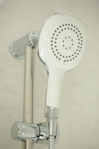 a shower head is attached to a wall at B&B Hotel Telsiai in Telšiai
