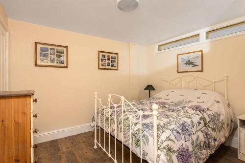 a bedroom with a white bed in a room at Poppy's Place Cupar in Cupar