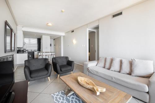 a living room with a couch and a table at Point Waterfront Apartments in Durban