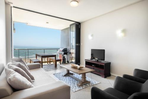 a living room with a couch and a tv at Point Waterfront Apartments in Durban