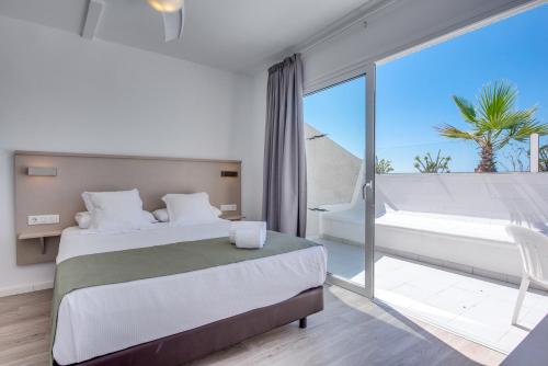 ein Schlafzimmer mit einem Bett und einem großen Fenster in der Unterkunft Vigilia Park in Puerto de Santiago