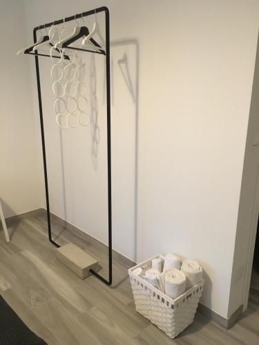 a rack with a basket of towels in a room at Four Rooms in Bologna