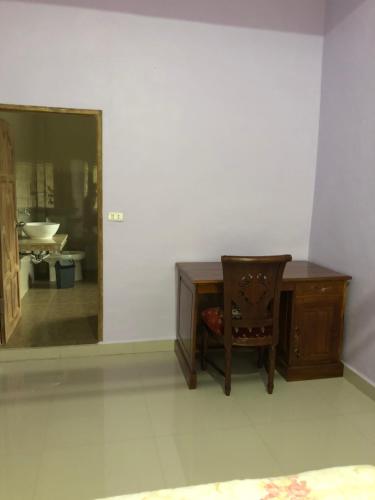 a desk and a chair in a room with a mirror at Marie'z Villa in Tuktuk Siadong