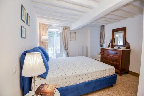 una camera con letto, cassettiera e specchio di Dreaming Apartments Lucca Leonardo a Lucca