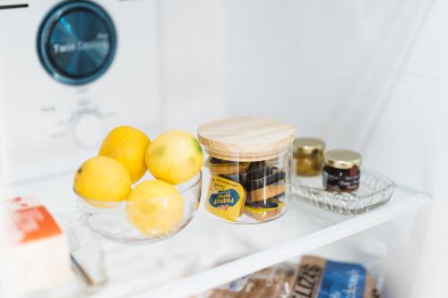 a shelf with apples oranges and other items in a refrigerator at Southlynne in Launceston