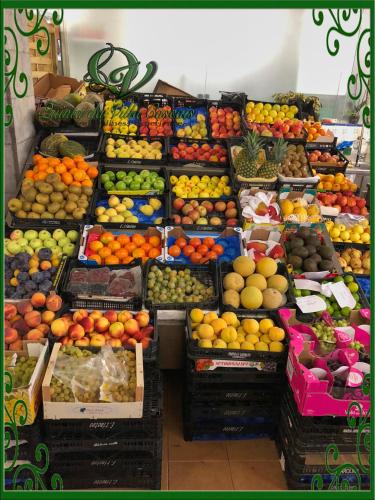 a display of fruits and vegetables in a market at Quinta da Villa in Cascais