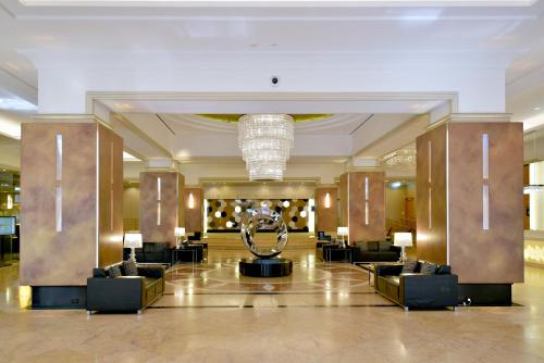 a lobby of a hotel with a sculpture in the middle at Duxton Hotel Perth in Perth
