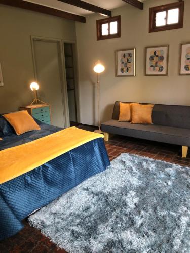 a living room with a bed and a couch at Rent apart Las Condes in Santiago