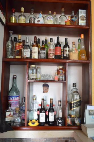 a shelf filled with lots of bottles of alcohol at Hostal La Casa De Rodrigo in Baeza