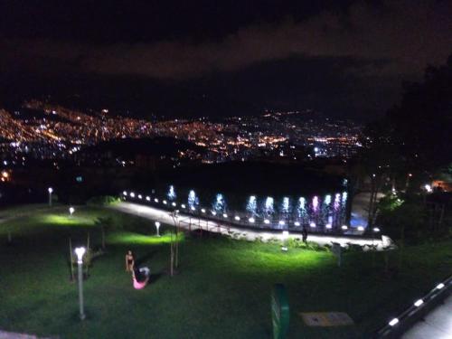 a park at night with lights in the grass at Apartamento Campestre Medellin in Medellín