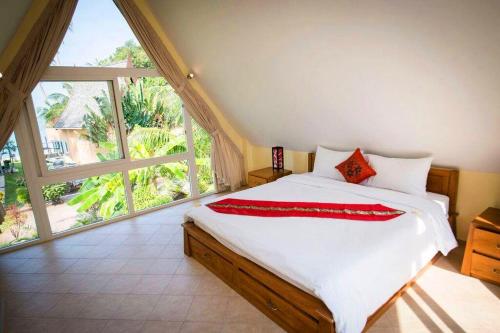 a bedroom with a large bed and a large window at Summer time villa in Trat