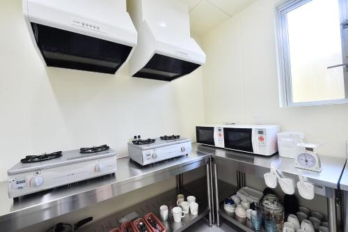 a kitchen with several appliances on a counter at Chura Cabin Kokusai-Dori in Naha