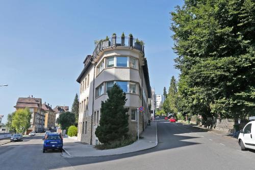a tall building on the side of a street at Les logis de l'horloger in La Chaux-de-Fonds
