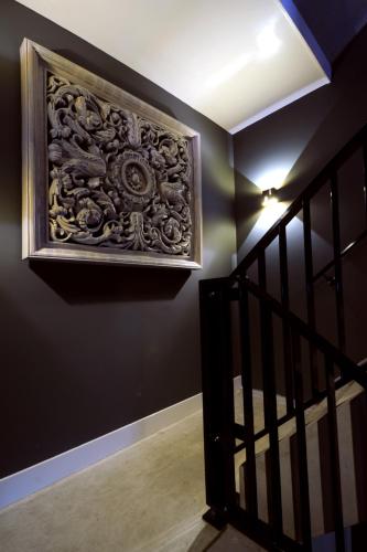 a stairway with a plaque on a black wall at Blue Mansion Hotel in Aalsmeer