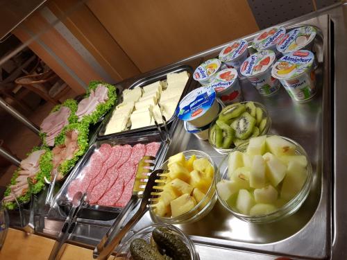 a buffet with different types of food on a counter at Hotel Habana in Aalen