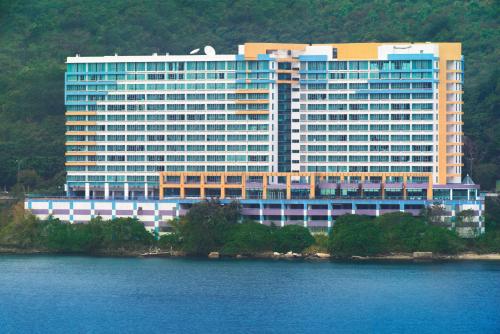 
a large blue and white building with a blue sky at Bay Bridge Lifestyle Retreat, managed by Tang’s Living in Hong Kong
