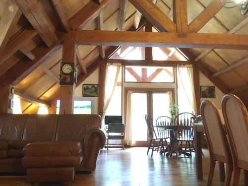 a living room with a couch and a table and chairs at Owl Street Lodge in Hope