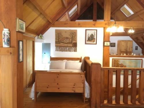 a bedroom with a bed and a wooden staircase at Owl Street Lodge in Hope