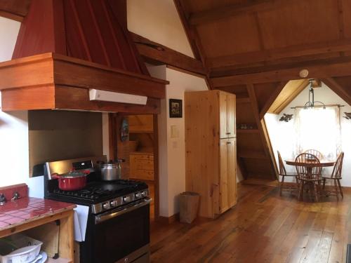 a kitchen with a stove with pots and pans on it at Owl Street Lodge in Hope