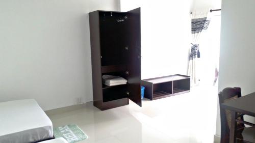 a bedroom with a black cabinet in the corner at Mahaweli View Inn in Kandy