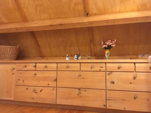 a wooden cabinet with a sink in a room at Owl Street Lodge in Hope