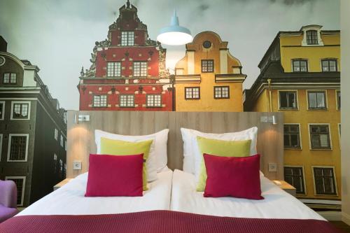 
a bedroom with a large bed and a large clock on the wall at ProfilHotels Central in Stockholm
