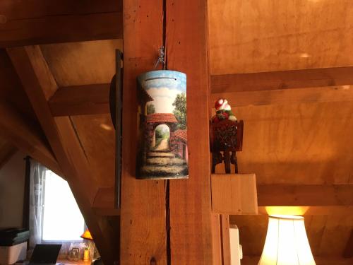 a vase on a wall with a picture on it at Owl Street Lodge in Hope
