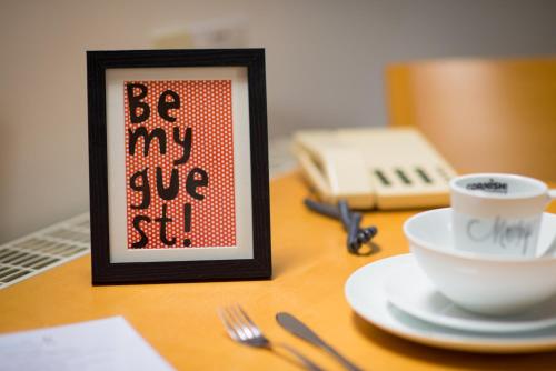 a picture of a sign on a table with a cup of coffee at Mannings Hotel in Truro