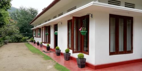 a row of houses with potted plants on them at Mahaweli Shades in Kandy