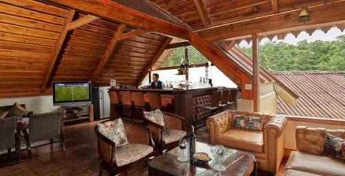 a living room with a bar in a cabin at The Heritage Club - Tripura Castle Hotel and Spa in Shillong