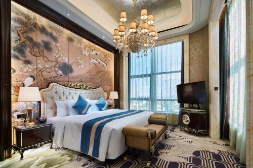 En eller flere senge i et værelse på Wanda Realm Qiqihar