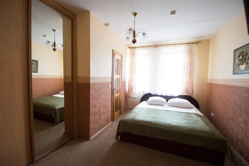 A bed or beds in a room at Svečių namai Lingės
