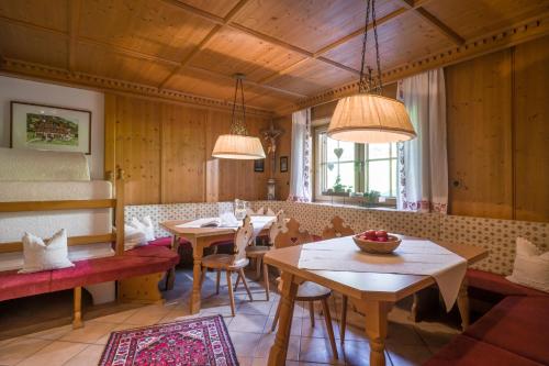 a dining room with tables and chairs and lights at Huaterhof in Zell am Ziller