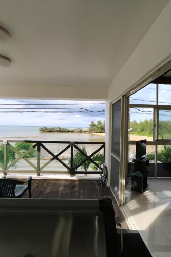a living room with a view of the ocean at T&T MOF-Maeda Ocean Front House- in Onna