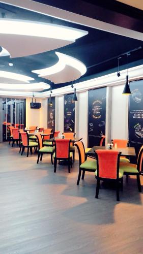 a dining room with tables and chairs in a restaurant at Soho Motel in Taoyuan