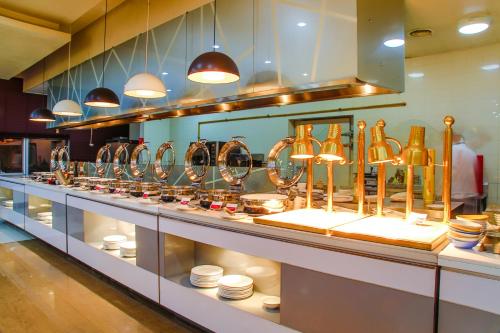 a display case in a restaurant with bowls and plates at Ramada Ulaanbaatar City Center in Ulaanbaatar