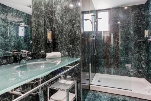 a bathroom with a shower and a sink and a tub at B&B HOTEL Castellón in Castellón de la Plana