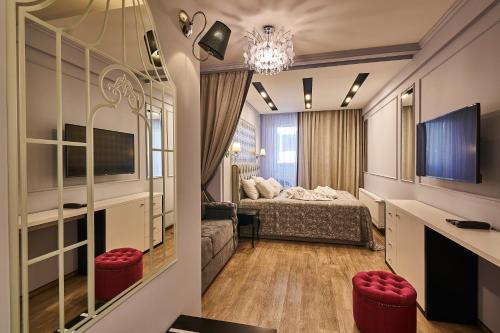 a hotel room with a bed and a television at Light Hotel in Dnipro