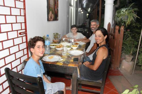 a group of people sitting at a table eating food at Old Dutch House in Galle