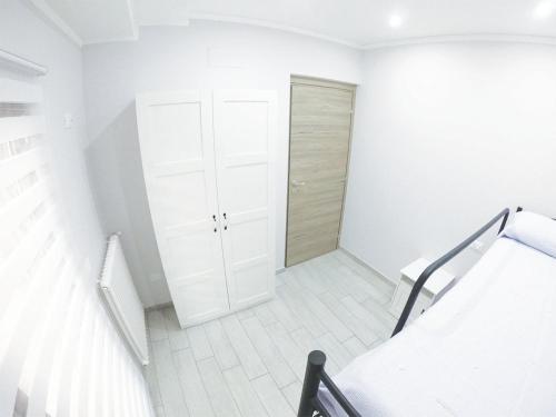 Dieses weiße Zimmer verfügt über ein Bett und einen Schrank. in der Unterkunft La Casetta Magliano De Marsi in Magliano deʼ Marsi