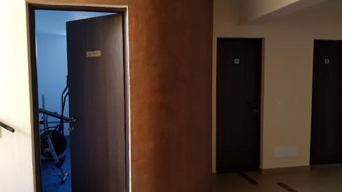 an open door in a room with two doors at Alba Forum in Alba Iulia