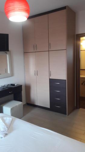 a bedroom with a bed and a large cabinet at Agnanti Villas in Nafpaktos
