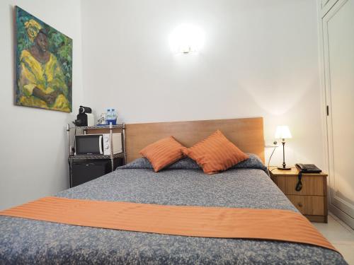 Ένα ή περισσότερα κρεβάτια σε δωμάτιο στο Hotel Montserrat