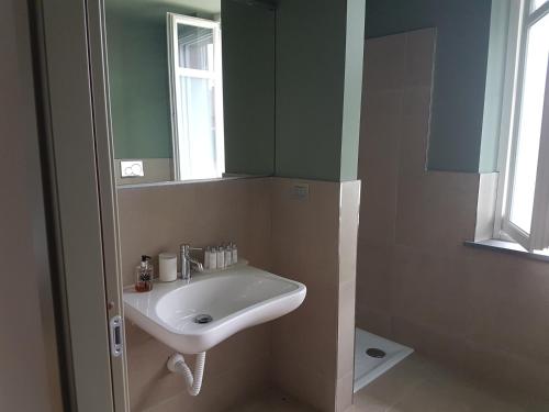 a bathroom with a sink and a mirror at Locanda Ferro UNO, Golf Città di Asti in Asti