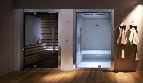 a large glass door in a room with a hallway at Splendido Bay Luxury Spa Resort in Padenghe sul Garda