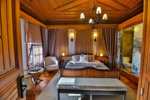 a bedroom with a large bed and a wooden ceiling at Kaf Konak in Bartın