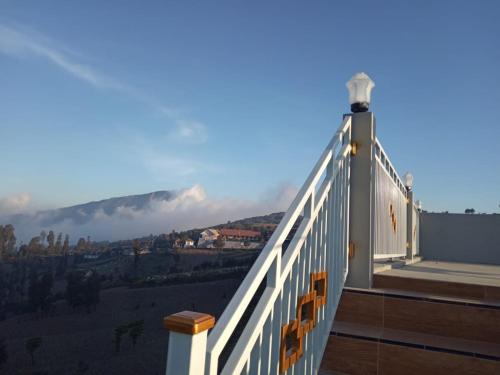 a balcony of a house with a view of a mountain at Bromo Otix Guest House in Bromo