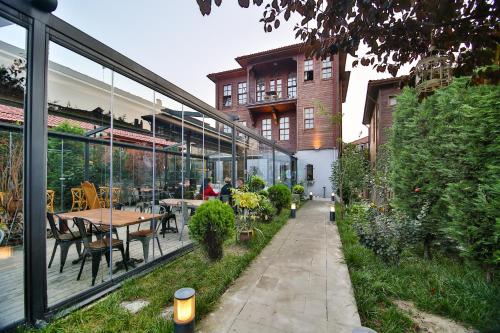 a garden with tables and chairs and a building at Kaf Konak in Bartın