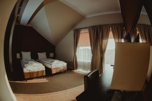 a hotel room with two beds and a window at Centrum Bankietowo - Hotelowe "Perła" in Leżajsk